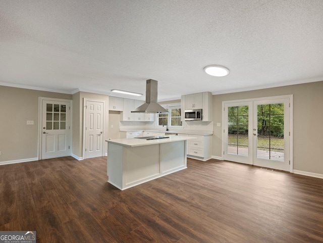 kitchen with white cabinets, dark hardwood / wood-style floors, and island range hood