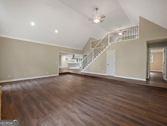 unfurnished living room featuring ceiling fan, dark wood-type flooring, high vaulted ceiling, and crown molding