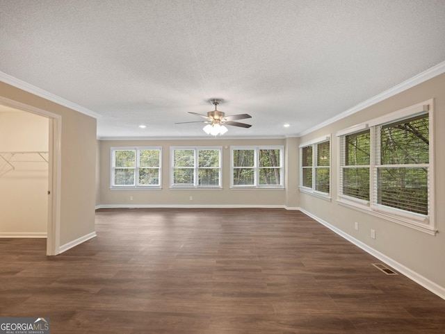 unfurnished living room with a textured ceiling, dark wood-type flooring, crown molding, and ceiling fan