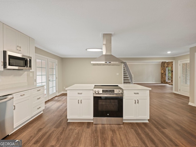 kitchen featuring island exhaust hood, white cabinets, and stainless steel appliances