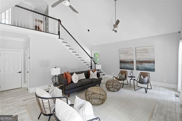 living room featuring ceiling fan, light hardwood / wood-style floors, and high vaulted ceiling