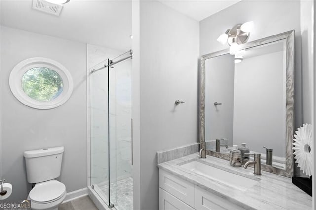 bathroom featuring vanity, toilet, and an enclosed shower