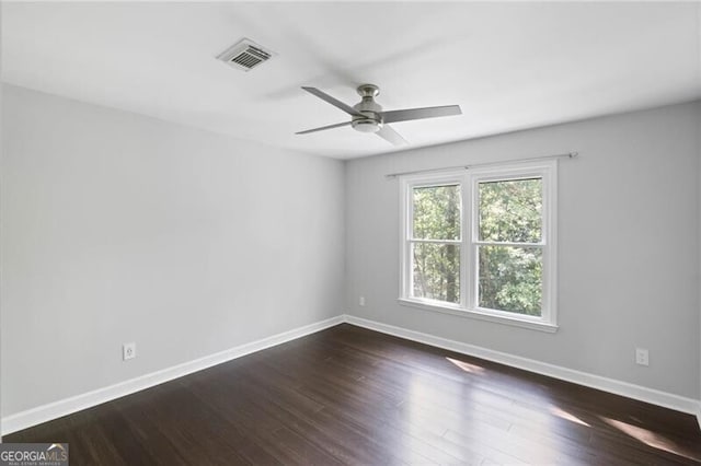 spare room with ceiling fan and dark hardwood / wood-style floors