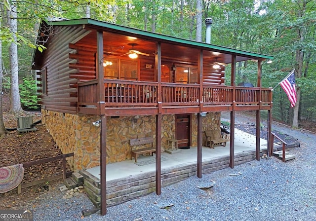 view of front of property with central air condition unit, a wooden deck, a patio area, and ceiling fan