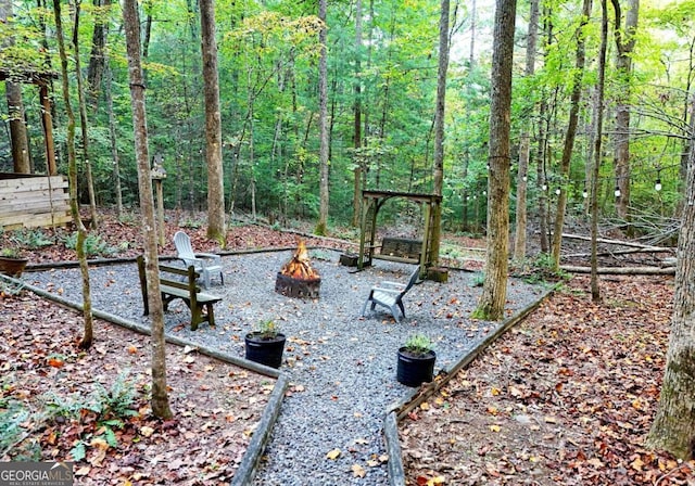 view of yard featuring an outdoor fire pit