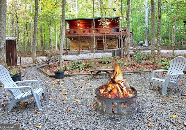 view of yard with an outdoor fire pit