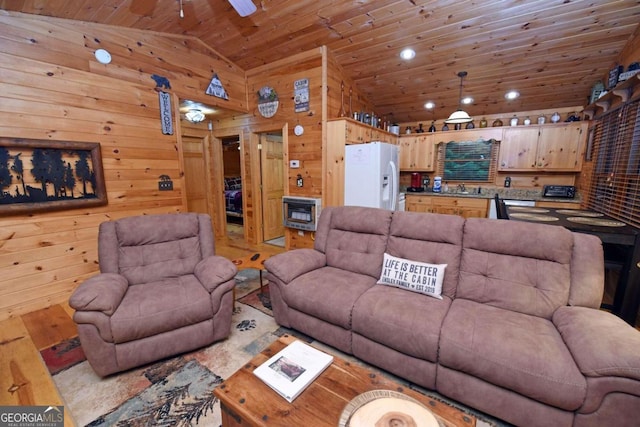 living room featuring ceiling fan, sink, wooden walls, high vaulted ceiling, and wooden ceiling