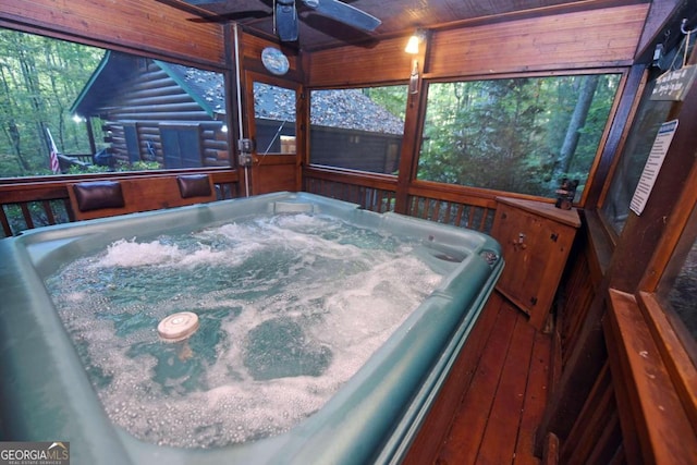 wooden terrace with a hot tub