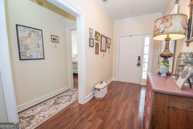 entrance foyer with a textured ceiling, crown molding, and dark wood-type flooring