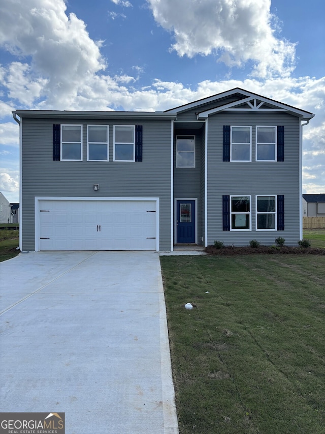 view of front of home featuring a front yard and a garage