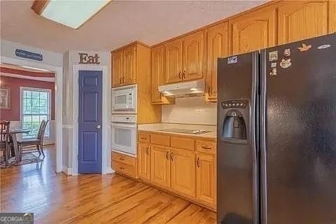 kitchen featuring white appliances and light wood-type flooring