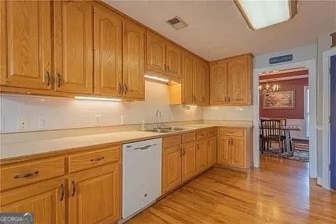 kitchen featuring sink, light hardwood / wood-style flooring, and dishwasher