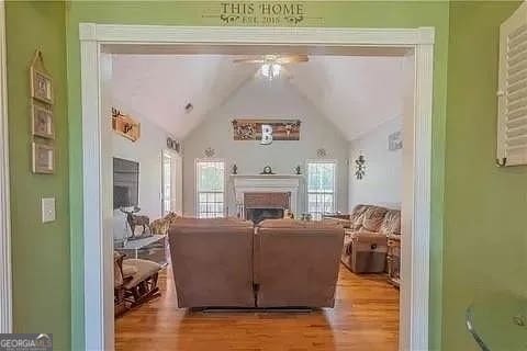 living room with light hardwood / wood-style flooring and lofted ceiling