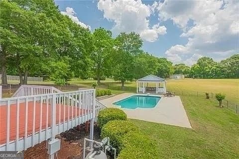 view of pool with a gazebo, a yard, and a patio