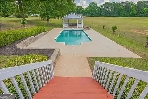 view of pool featuring a gazebo, a yard, and a patio area