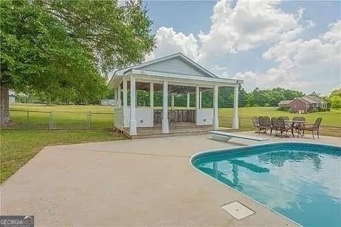 view of pool featuring a patio and a lawn