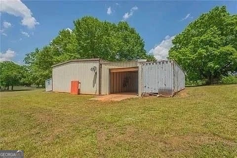 view of outbuilding with a yard