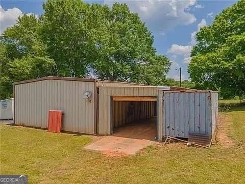 view of outbuilding featuring a lawn