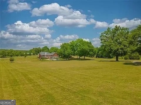 view of home's community featuring a yard and a rural view