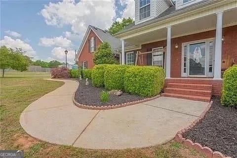 property entrance featuring a yard and a porch