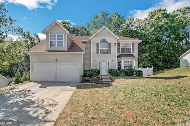 view of front of home featuring concrete driveway, a shingled roof, and a front yard