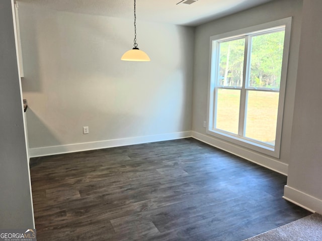 unfurnished dining area featuring dark wood-type flooring