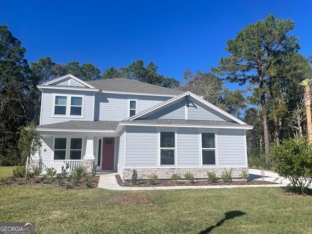 craftsman house featuring covered porch and a front yard