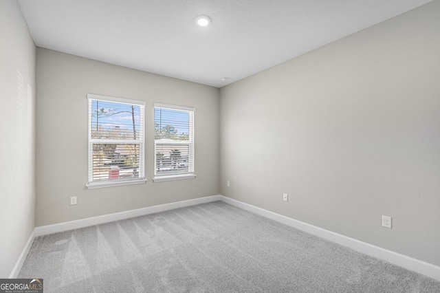 spare room with light colored carpet