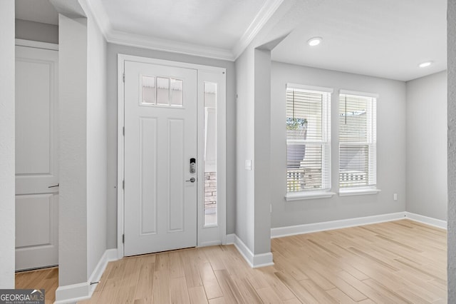 entrance foyer with light wood-type flooring and ornamental molding