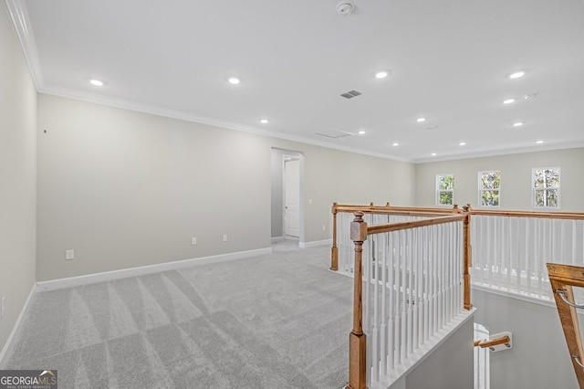 carpeted spare room with crown molding