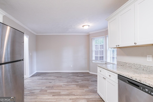 kitchen with ornamental molding, light stone counters, light wood-style flooring, white cabinets, and appliances with stainless steel finishes