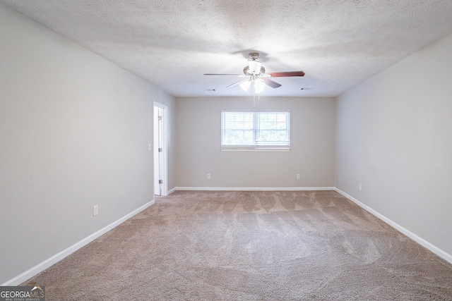 spare room with carpet floors, a textured ceiling, and ceiling fan