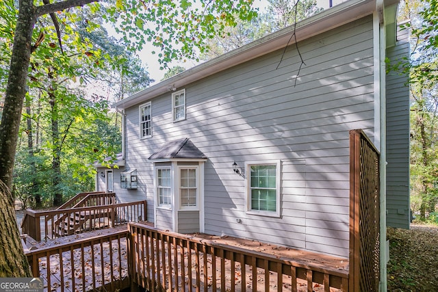 rear view of property featuring a deck