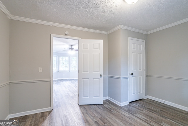 spare room with ornamental molding, hardwood / wood-style floors, and a textured ceiling