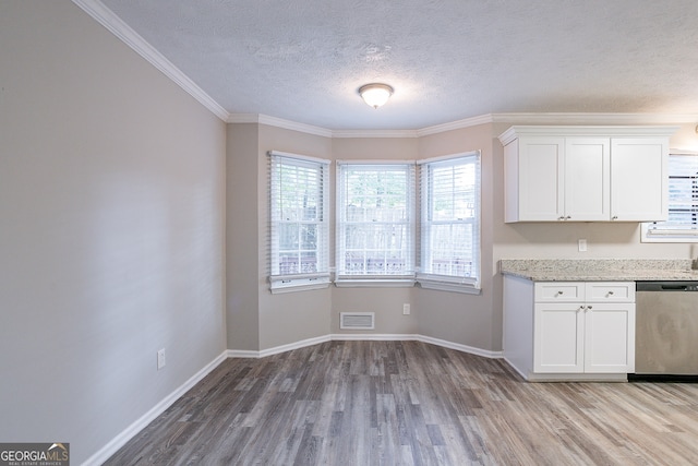 kitchen with ornamental molding, hardwood / wood-style flooring, stainless steel dishwasher, and white cabinets