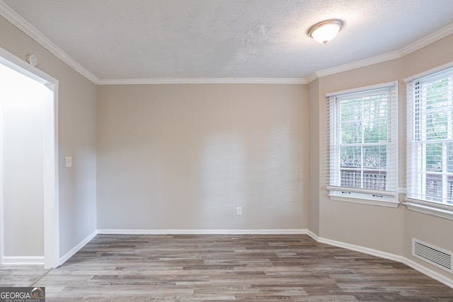 unfurnished room with wood-type flooring, a textured ceiling, and crown molding