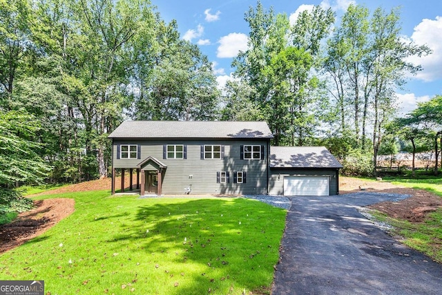 view of front of house with a front lawn and a garage