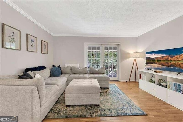 living room with ornamental molding, a textured ceiling, and hardwood / wood-style flooring