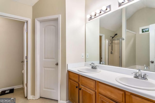 bathroom with lofted ceiling, tile patterned floors, a shower with door, and vanity