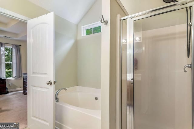 bathroom with shower with separate bathtub and vaulted ceiling