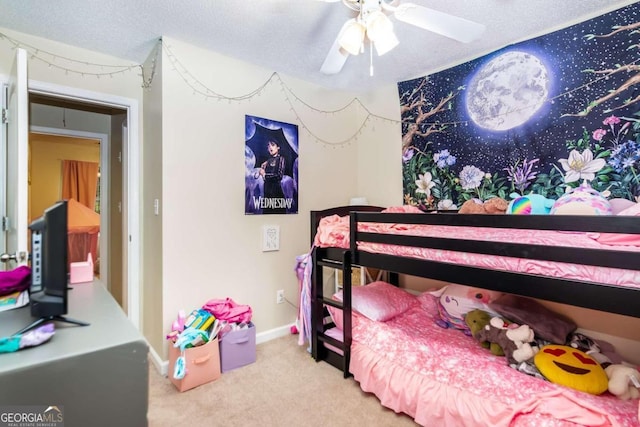 bedroom featuring carpet flooring, a textured ceiling, and ceiling fan