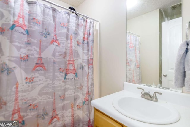 bathroom featuring vanity and a textured ceiling