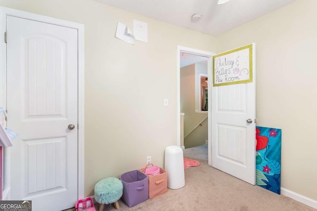 game room featuring light carpet