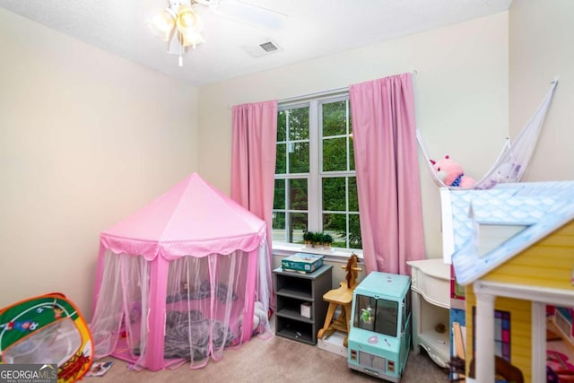 playroom with ceiling fan and carpet floors