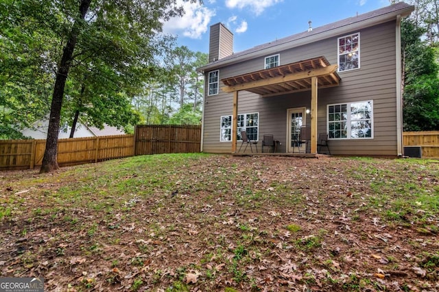 rear view of property featuring central AC