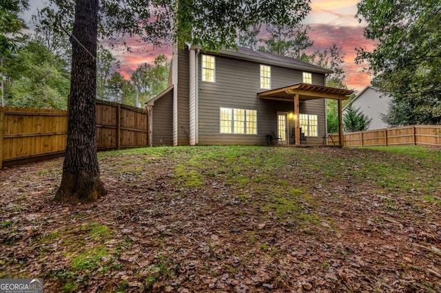 view of back house at dusk