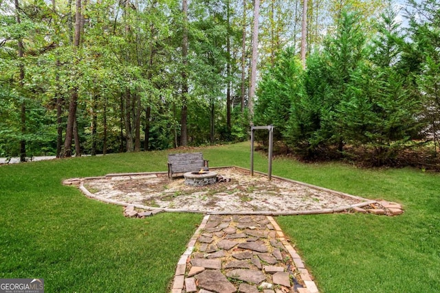 view of yard with a fire pit