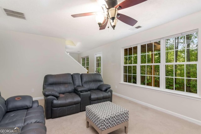 living room featuring ceiling fan and light colored carpet