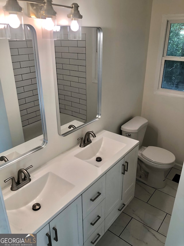 bathroom featuring toilet and vanity