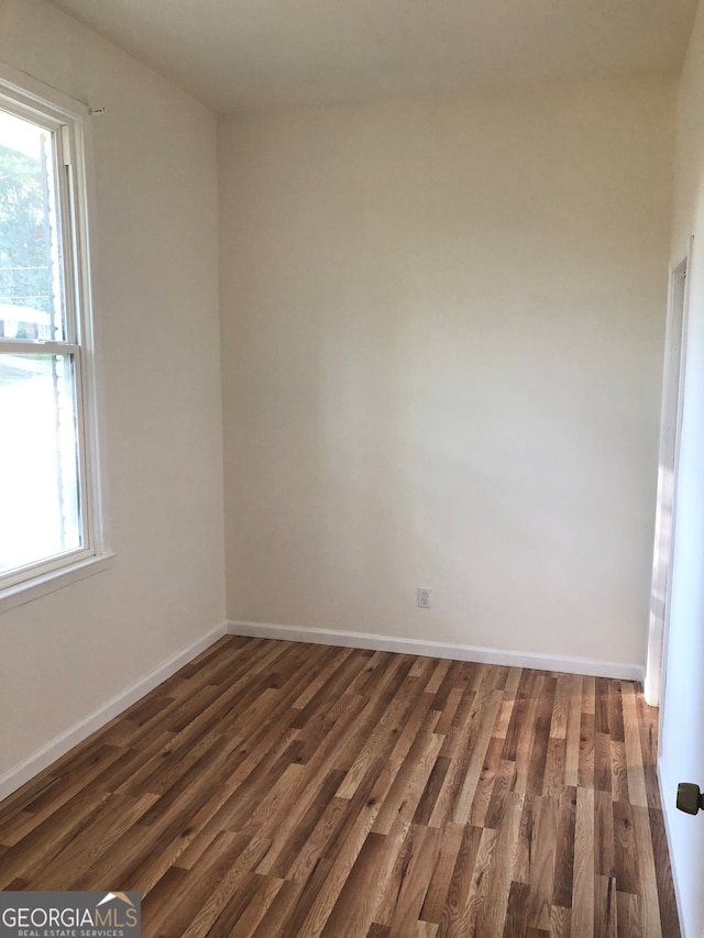 empty room featuring dark wood-type flooring